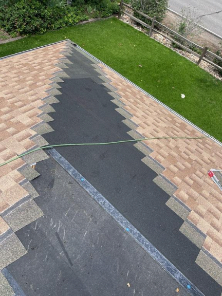 Residential roofingprojectnearingcompletionwithnewasphaltshingles installedby professional roofingcontractor
